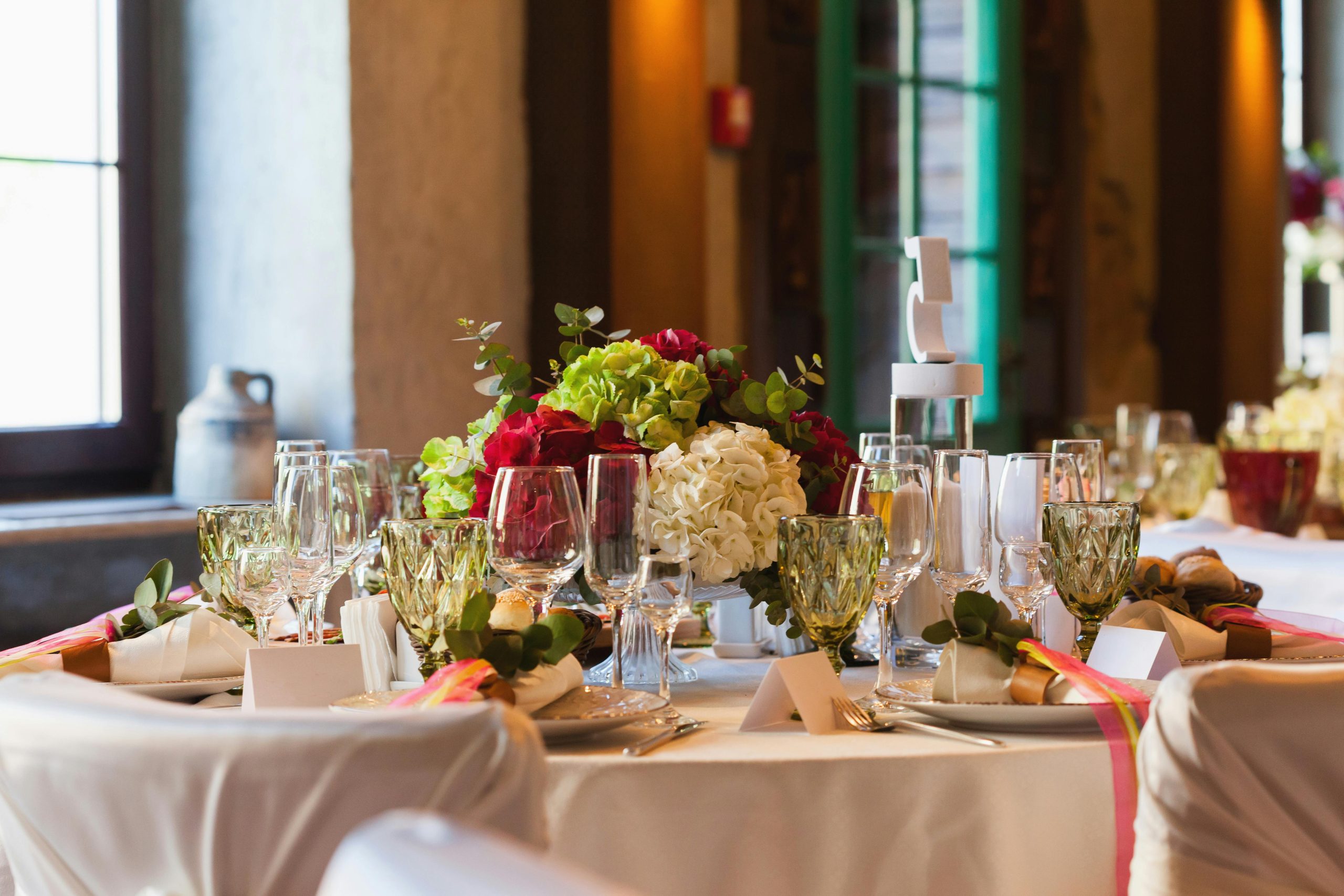 Beautifully arranged table setting with elegant tableware and a vibrant floral centerpiece.